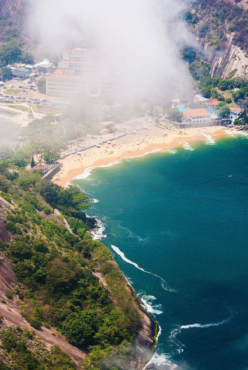 aerial view fog covering mountain near body of water cloud